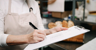 Buy stock photo Baker, hands and writing on document in kitchen for supplies, stock or order. Pastry chef, clipboard and woman in bakery for inventory notes, checklist and schedule with signature in business