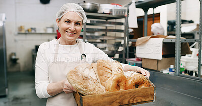 Buy stock photo Woman, bakery and happy with bread basket in portrait, pride and entrepreneur with product at store. Mature person,  smile and small business owner in kitchen for pastry, buns and bagels in Germany