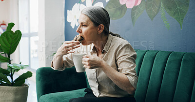 Buy stock photo Coffee, cookie and mature woman in cafe for breakfast, sweet treat or snack in morning. Cappuccino, relax and female person eating biscuit with warm beverage on sofa in restaurant on weekend.