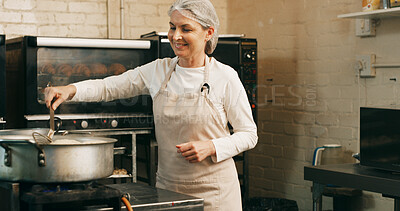 Buy stock photo Baker, woman and frying donuts in kitchen for lunch order, baking process and catering service. Small business, mature person and happy with dessert preparation in restaurant for gastronomy and snack