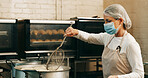 Mask, baker or frying donuts in kitchen for dessert production, baking process or catering. Hospitality industry, mature person and lunch snack preparation in bakery for gastronomy or culinary safety