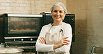 Woman, happy and arms crossed for portrait at bakery, oven and confident with dough for pastry at shop. Person, baker and small business owner with bread, smile or kitchen at store in Germany