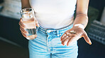 Hands, woman and water with pills in home for prescription drugs, supplements and medication. Healthcare, routine and person with tablets in apartment for health benefits, vitamins or chronic illness