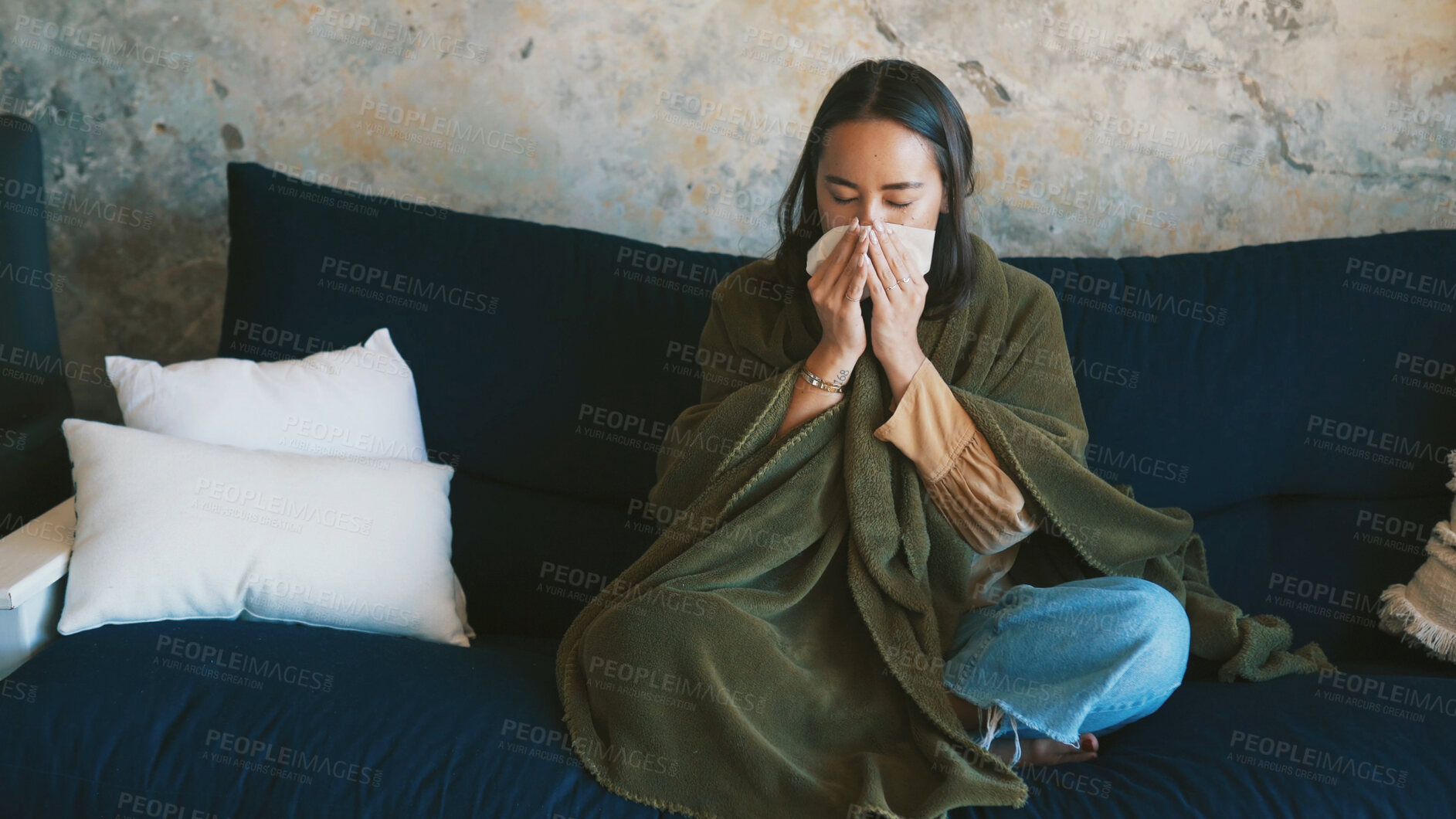 Buy stock photo Blanket, woman and sick with blowing nose on sofa from viral infection, disease and flu recovery. Respiratory illness, person and sneeze in tissue from influenza, nasal congestion and fever in home
