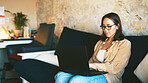 Student, laptop and glasses with woman on sofa for college essay, online course and research thesis. University assignment, scholarship application and online with person in living room of home