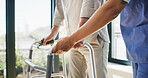 Walker, nurse and hands of elderly man for help, support and medical service. Healthcare, retirement home and caregiver with walking frame for senior person with disability for rehabilitation