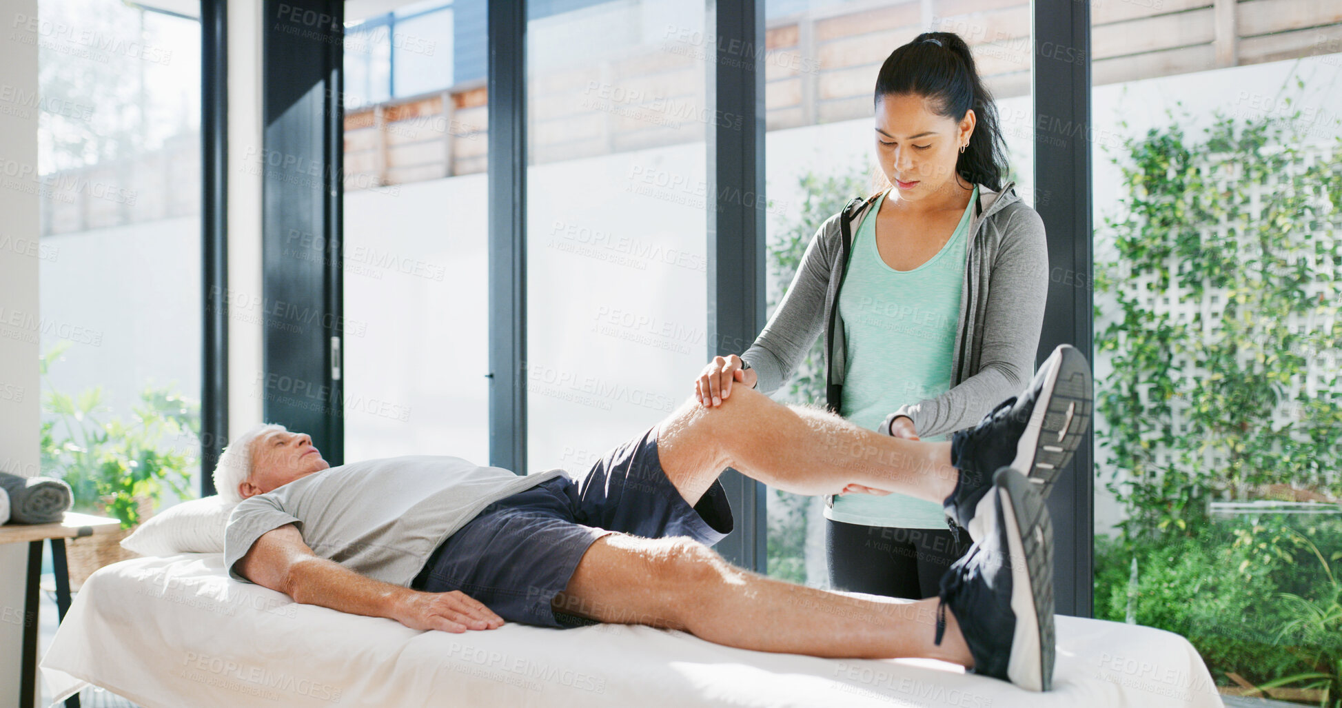 Buy stock photo Physiotherapy, stretching legs or old man in clinic, checkup or mobility support in rehabilitation. Healthcare, assessment or specialist in center with aid, injury or muscle recovery in retirement.
