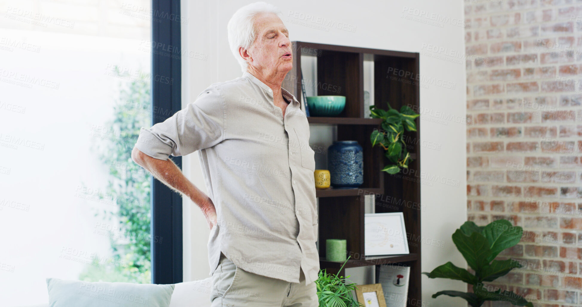 Buy stock photo Back pain, fatigue and retirement with old man in living room of home for condition or discomfort. Posture, spine and stiff with senior person in apartment for arthritis or muscle inflammation