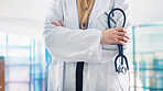 Stethoscope, hands and doctor with arms crossed in hospital, healthcare professional or cardiology career. Medical specialist, confident and woman with health support, cardiac care and heart wellness