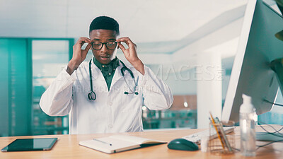 Buy stock photo Computer, glasses and notebook with doctor black man at desk in hospital for results review. Healthcare, medical and research with medicine professional in office at clinic for agenda or schedule