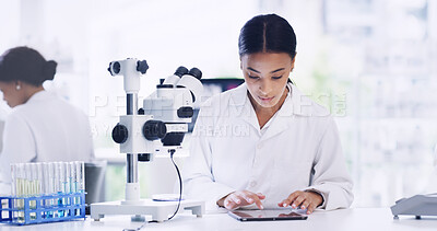 Buy stock photo Woman, scientist and reading on tablet in lab for research, medical study and experiment results. Person, coworking and microscope with digital checklist, online report and review feedback on vaccine