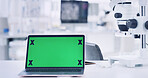 Laptop, green screen and microscope in laboratory for research, medical study and testing sample. Equipment, pc and biotechnology for experiment, observe organisms and email for vaccine development