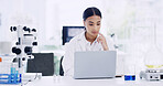 Laptop, woman and scientist in laboratory for medical project, research or healthcare innovation. Science, reading and female biologist with clinical trial for pharmaceutical development on computer.