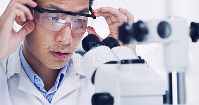 Buy stock photo Man, scientist and forensic with microscope for medical research or discovery in laboratory. Male person, goggles and scientific study with biotechnology for science investigation, exam or test
