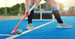 Hockey stick, ball and legs on turf for training practice, physical activity and sports game outdoor. Fitness, coordination and athlete with control on field for passing,  match preparation and flare
