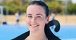 Portrait, hockey and happy girl on field for training, fitness and competition outdoor for health. Woman, athlete and player with stick for sports, smile and confidence for exercise  with game