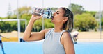 Woman, fitness or drinking water with bottle on court for sport, hydration or outdoor break. Active, female person or thirsty player with mineral liquid, aqua or beverage for health, rest or recovery