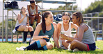 Fitness outdoor and women with smartphone, relax and discussion with game results. Online chatting, people and friends on grass field, cellphone and communication with training, connection and break