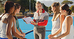 Coach, explain strategy with clipboard to athlete for college hockey match, tournament or practice. Sports manager, people or talk with game plan on turf for tactical info, formation or instructions.