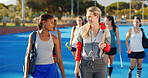 Finish, hockey and women outdoor with coach talking after training, practice and exercise. Team, happy and people in conversation after playing match, game and tournament on turf for sports hobby