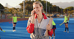 Coach, hockey field and woman with phone call for match organization, conversation and event info.Planning, mobile and sport trainer with clipboard on turf, game arrangement and local league opponent