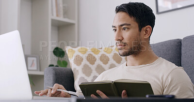 Buy stock photo Man, student and laptop with book in home, research and review project for online course in lounge. Person, planning and computer with scroll, assessment or elearning with education on web at house