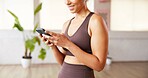 Phone, smile and hands of woman in yoga studio typing for communication with online app. Fitness, gym and female person with technology for networking, contact and social media in pilates class