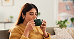 Calm, drinking or Indian woman on sofa with coffee cup, satisfied or reflection in morning routine. Sip, aroma or female person in house with mug, mood improvement or mindfulness at start of day.