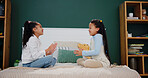 Girl, kids playing and game in bedroom with hands,  coordination and cooperation in bonding activity. Sisters, fun challenge and children on bed together for contest, support or entertainment in home
