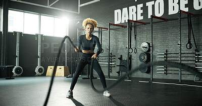 Buy stock photo Woman, battle rope and workout in gym for cardio, exercise and body building for fitness. Intense routine, muscle and wellness with power for strength training, weight equipment and bicep challenge