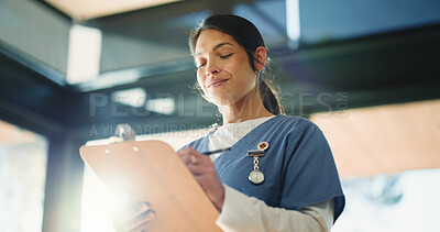 Buy stock photo Doctor, happy woman or reading with clipboard in clinic, medical record or writing instructions for care plan. Healthcare, patient treatment or person review chart for information, flare or low angle
