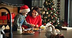Christmas, mother and child baking cookies in kitchen, learning and help with parent on holiday. Xmas, happy mom and bake with girl, sprinkles or teaching with preparation of festive food in home