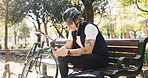 Cyclist, smartphone and man with internet, relax and connection with app for direction. Bike, mobile user and person on bench, cellphone and network for location, social media and online reading
