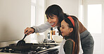 Cooking, pan or teaching with mother and daughter in kitchen of home for bonding or development. Learning, spatula or stove with girl child and single parent woman in apartment for recipe process