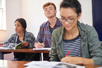 Buy stock photo University student, man and copying test in classroom with reading, question paper and answers at campus. Person, cheating and exam with women, information and assessment for education at college
