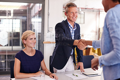 Buy stock photo Businessman, handshake and happy at office meeting, success or agreement at investment agency. Woman, men and shaking hands with documents, team and motivation for achievement at financial company