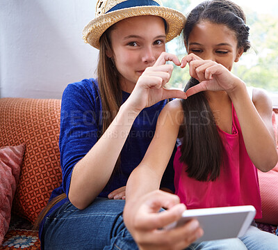 Buy stock photo Teens, selfie and friends with smile on sofa for social media, bonding and reunion in living room. Tech, girls and online app with profile picture, heart gesture with love on couch in apartment