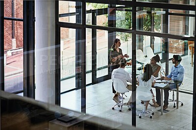Buy stock photo Shot of a group of businesspeople having a meeting in a boardroom