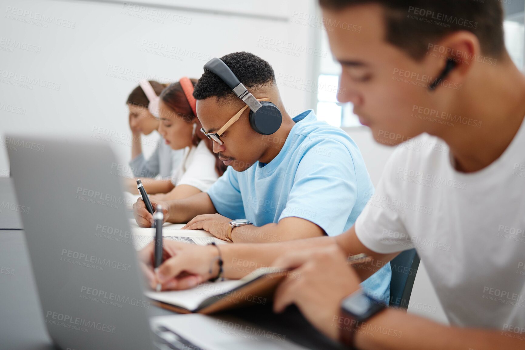 Buy stock photo Music, laptop and university student studying for exam with technology for online course information, research class. College people with headphones for elearning translation audio and writing notes