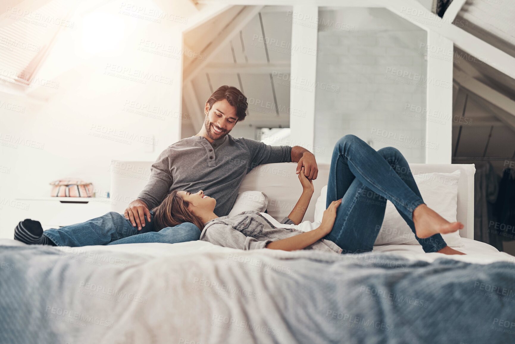 Buy stock photo Relax, couple and holding hands in bed in the morning with love, bonding and care together in a home with a smile. Chat, marriage and romance of happy people in a bedroom with support and commitment