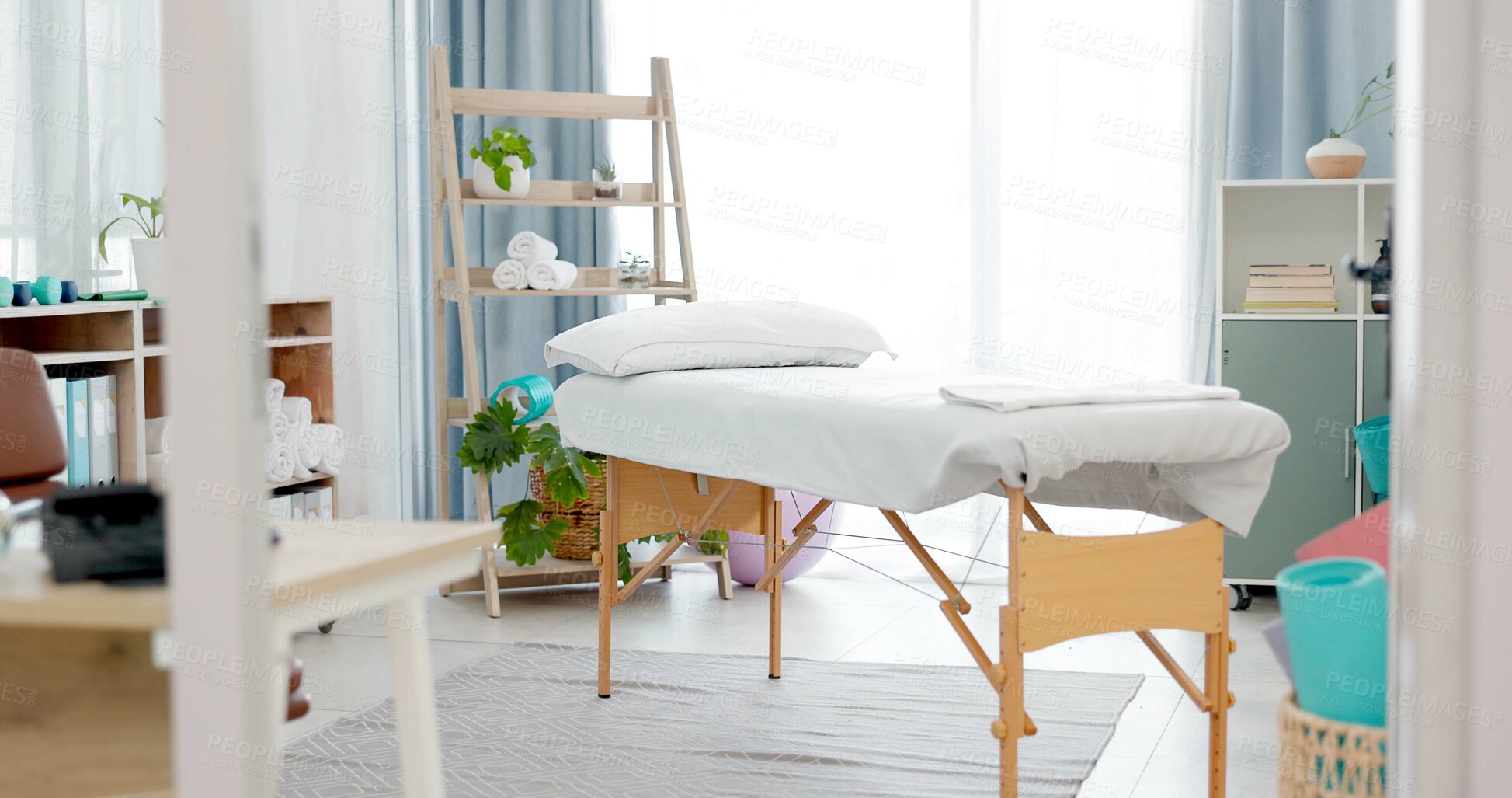 Buy stock photo Therapy room, empty and a bed for physiotherapy, hospital exam or healthcare test. Clinic bedroom, medicine and gear and tools in an chiropractic or orthopedic office for a consultation or check