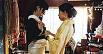 Asian woman, dress and fashion designer with garment for kimono, culture or tradition style at boutique. Japan, female people or tailor with customer, waist belt or clothing design for outfit at shop