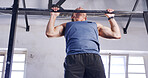 Low angle, pull up bar and fitness with man in gym for ab exercise, health and challenge. Strength training, bodybuilder and workout with person in sports club and equipment for athlete