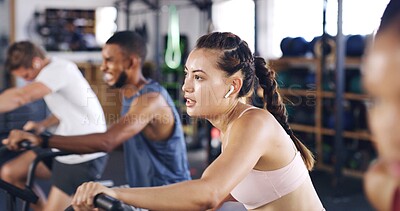 Buy stock photo Spin class, cardio and earphones with woman in gym for intense workout, music and cycling challenge. Fitness, streaming and stationary bike machine with people in sports club for health and energy