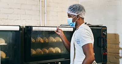 Buy stock photo Croissant, baker and oven with man in kitchen for cooking, culinary process and food production. Health, wheat and baking with person in coffee shop for catering, restaurant and small business owner