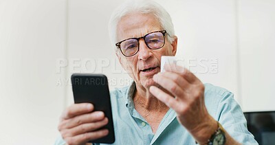 Buy stock photo Reading, pills and phone with old man in home for dosage instruction, medicine and side effects. Research, online pharmacy and medical information with senior person in apartment for prescription