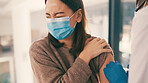Doctor, woman and vaccine injection with pain, virus prevention or medicine in clinic. Syringe, sore and immunization with patient for medical protection, healthcare and immune system boost with PPE