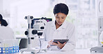 Woman, scientist and research with tablet in lab for notes, medical study and experiment results. Person, coworking and microscope with digital checklist, online report and review feedback on vaccine