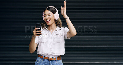 Buy stock photo Happy woman, dancing and music with headphones or phone on a dark studio background. Female person, user or model listening on mobile smartphone for audio streaming, entertainment or podcast on space