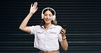 Happy woman, listening and music with headphones or phone on a dark studio background. Female person, user or model dancing on mobile smartphone for audio streaming, entertainment or podcast on space
